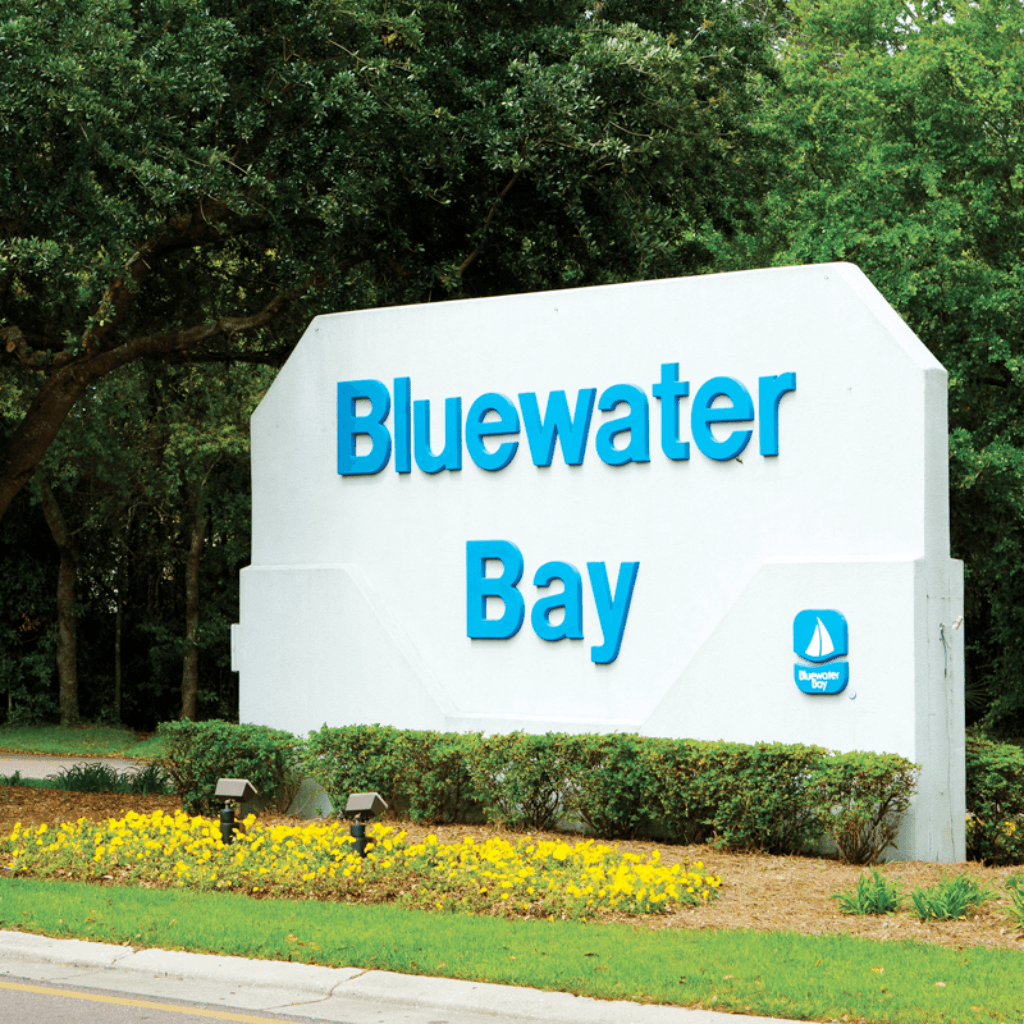 Bluewater Bay Florida entrance sign with landscaping and trees