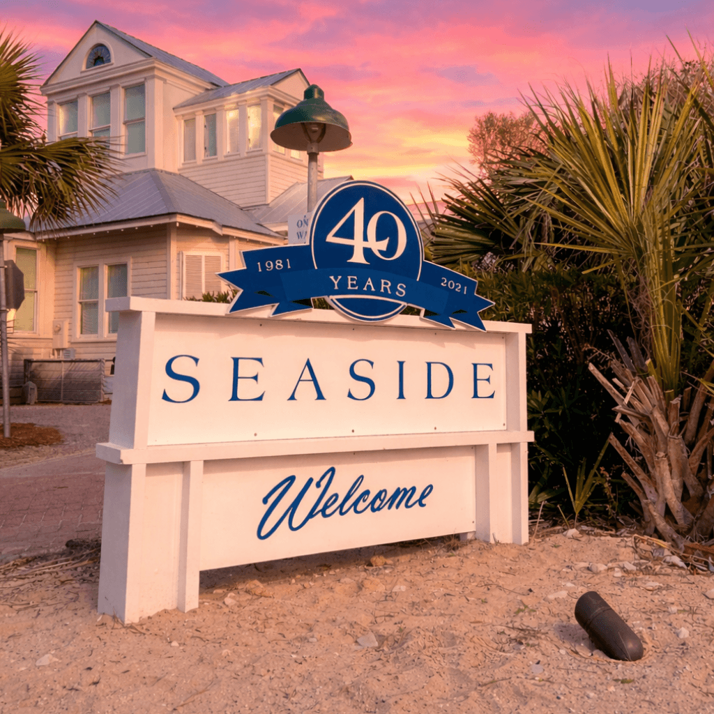 Seaside Florida welcome sign with coastal homes at sunset